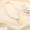 Collier acier inoxydable cœur sacré perle acrylique 0125189 doré
