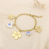 Bracelet fleurs martelées acier perles porcelaine 0226130 doré